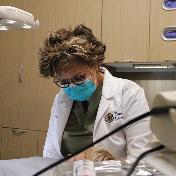 Dr. Martha Anne Carr cleaning a patient's teeth