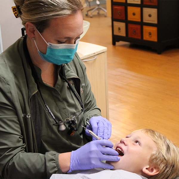Dr. Mary Cathrine Lyle cleaning a patient's teeth
